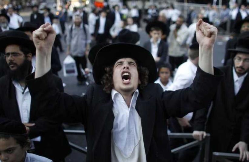 An ultra-Orthodox Jew gestures during a protest in the Mea Shearim neighborhood of Jerusalem (photo credit: REUTERS)