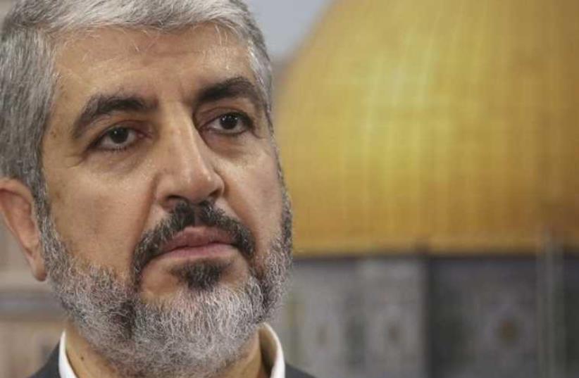 Hamas leader Khaled Mashaal speaks during an interview with Reuters in Doha (photo credit: REUTERS)