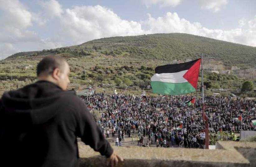 Israeli Arab demonstrators take part in a Land Day rally in the northern village of Deir Hanna (photo credit: REUTERS)