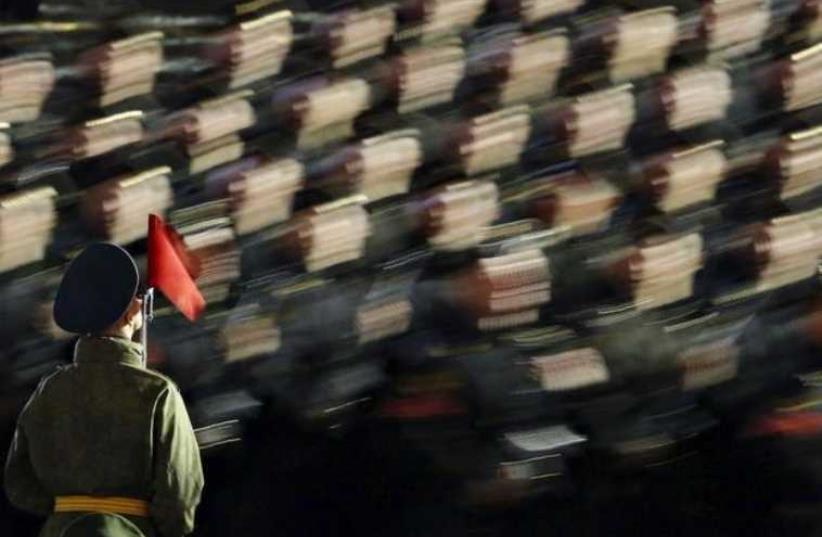 Russian servicemen take part in a rehearsal for the Victory parade on Moscow's Red Square (photo credit: REUTERS)