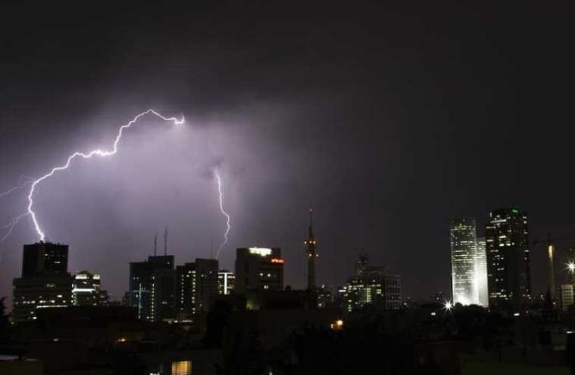 Lightning strikes over the skyline of Tel Aviv during a rain storm (photo credit: REUTERS)