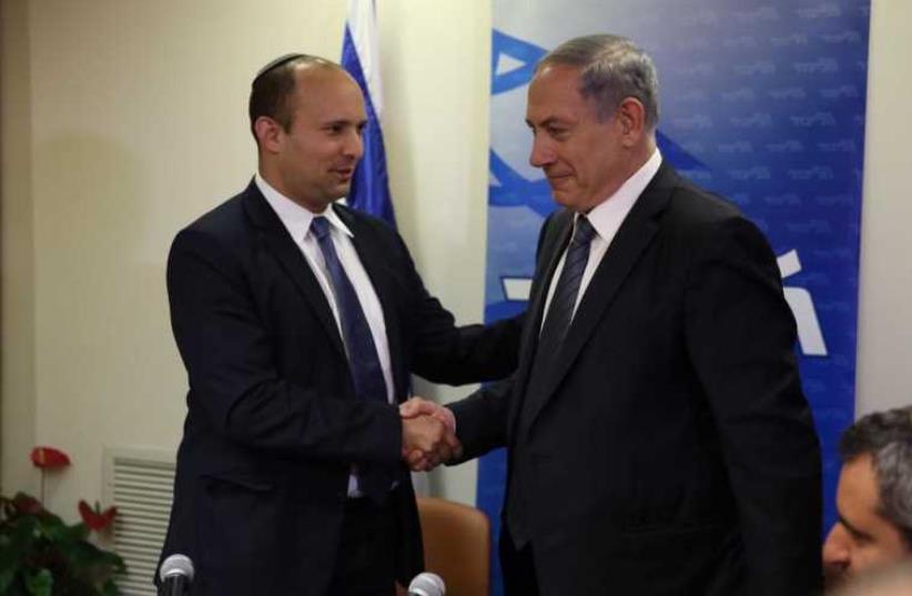 Prime Minister Benjamin Netanyahu (R) shakes hands with Bayit Yehudi chief Naftali Bennett (photo credit: TWITTER / TAL SCHNEIDER)