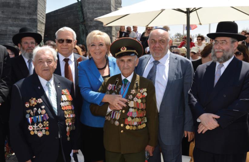 NETANYA MAYOR Miriam Feirberg Ikar stands with World War II Jewish veterans at a ceremony to mark 70 years since VE Day in the coastal city on Wednesday. (photo credit: RAN ELIYAHU)