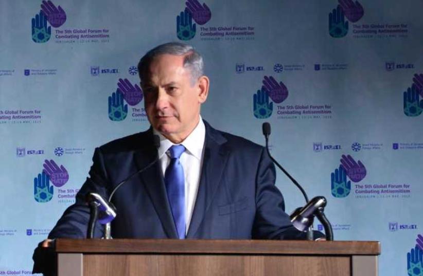Prime Minister Benjamin Netanyahu speeks at the fifth Global Forum for Combating anti-Semitism (photo credit: KOBY GIDEON/GPO)