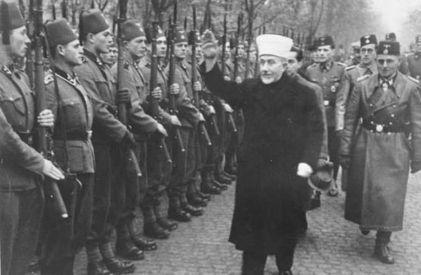Nakba instigator Husseini giving the Heil Hitler salute to Bosnian Muslim volunteers to the notorious Waffen SS (the Hanzar SS Division) in November, 1943 [Jerusalem Post Archives]    (photo credit: JERUSALEM POST ARCHIVE)