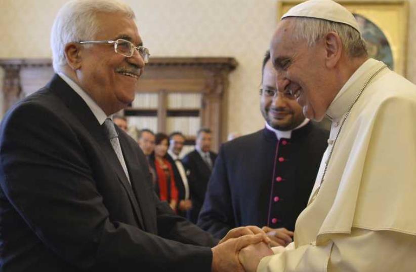 Pope Francis (R) shakes hands with Palestinian Authority chief Mahmoud Abbas in the Vatican (photo credit: REUTERS)