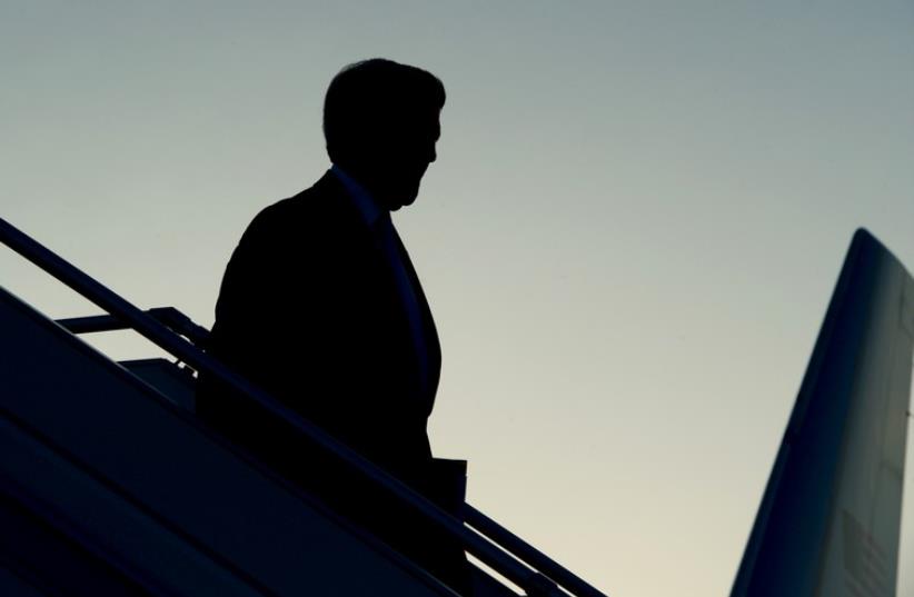 US Secretary of State John Kerry is seen in silhouette as he deplanes against an evening sky after arriving in Geneva, Switzerland, on May 29, 2015 (photo credit: STATE DEPARTMENT PHOTO)