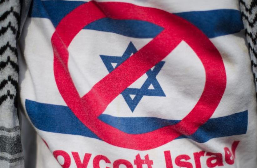A demonstrator wears a shirt reading 'Boycott Israel' [File] (photo credit: AFP/ MOHD RASFAN)