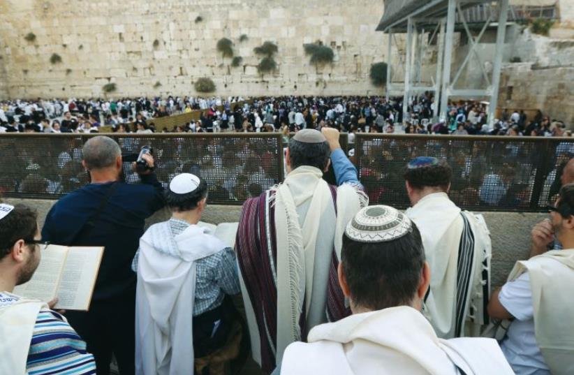 Men of the Women of the Wall pray behind the partition at the back of the women’s section, in 2013. (photo credit: MARC ISRAEL SELLEM/THE JERUSALEM POST)