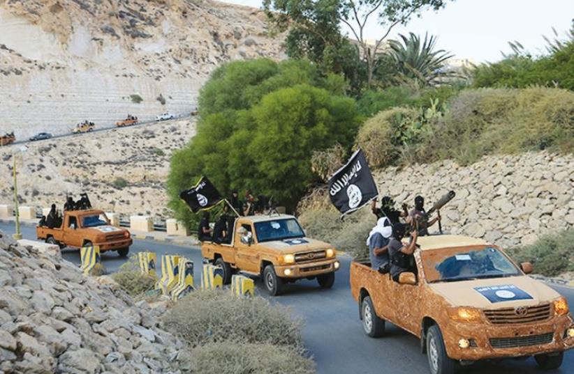 An armed motorcade belonging to members of Derna’s Islamic Youth Council drives along a road in the town of Derna in eastern Libya on October 3, 2014, a day after the group pledged allegiance to the Islamic State. (photo credit: REUTERS)