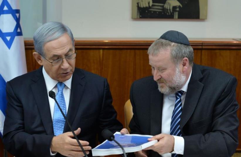Prime Minister Benjamin Netanyahu receives report with findings on Operation Protective Edge.‏ (photo credit: KOBI GIDEON/GPO)