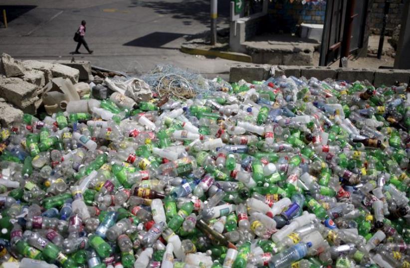 Plastic bottles to be sold for recycling are seen at a storage (photo credit: REUTERS)