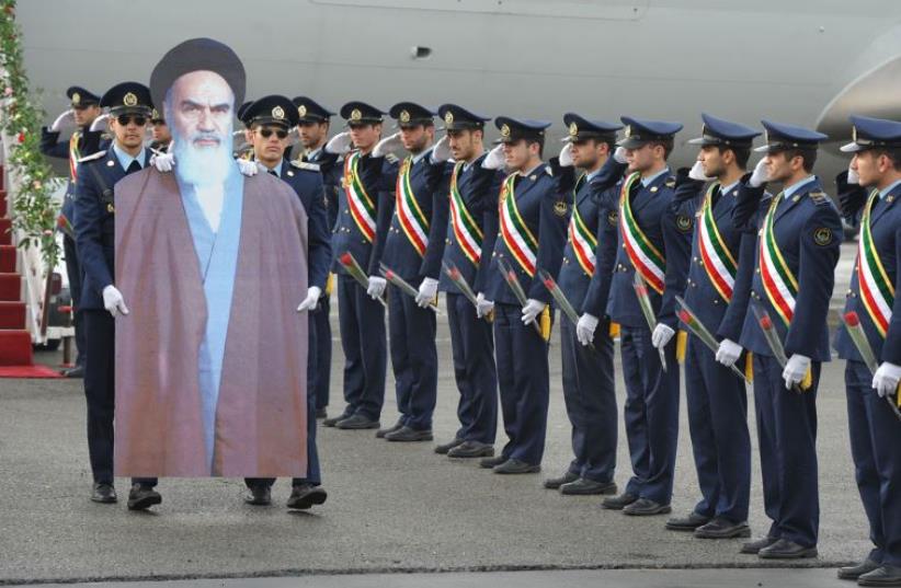 Members of the Iranian air force re-enact the scene of founder of the Islamic Republic Ayatollah Ruhollah Khomeini's arrival to Iran in 1979 at Merhrabad airport (photo credit: REUTERS)