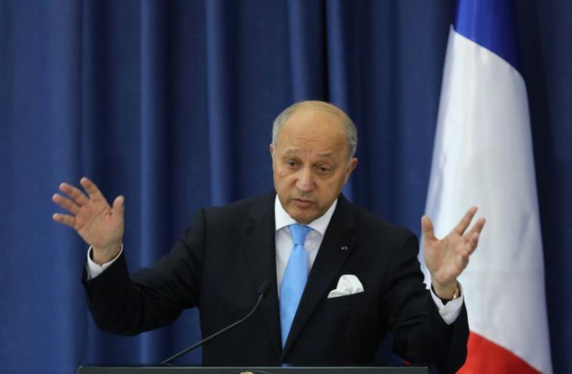 French Foreign Minister Laurent Fabius gestures during a press conference at the Mukataa compound, in the West Bank city of Ramallah, on June 21, 2015.  (photo credit: ABBAS MOMANI / AFP)