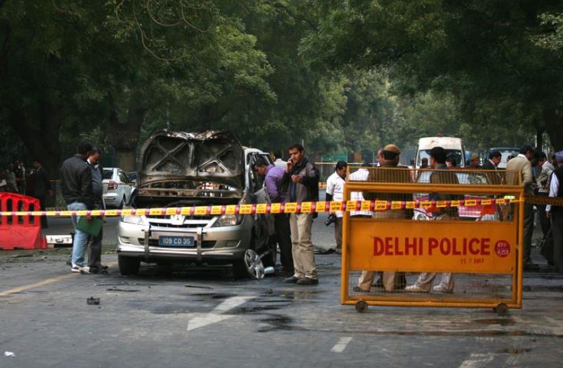 Police and forensic officials examine a damaged Israeli embassy car after an explosion in New Delhi February 13, 2012. (photo credit: REUTERS)
