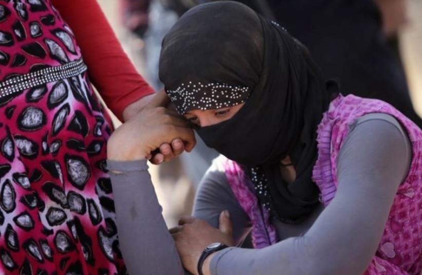 Yazidi refugee. (photo credit: AHMAD AL-RUBAYE / AFP)