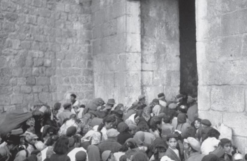 EXPELLED JEWS are shoved out of Zion Gate in Jerusalem after it was conquered by the Arab Legion (photo credit: JERUSALEM POST ARCHIVE)
