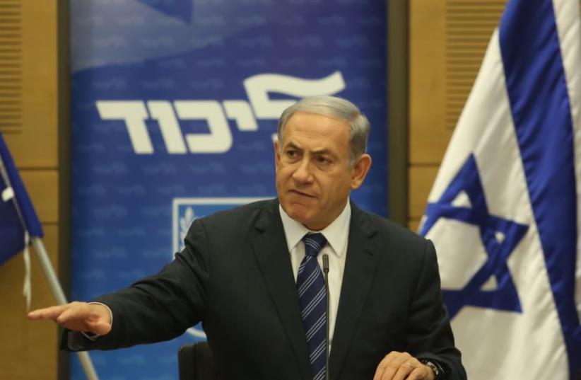 Prime Minister Benjamin Netanyahu gestures during an appearance at a Likud faction meeting (photo credit: MARC ISRAEL SELLEM)