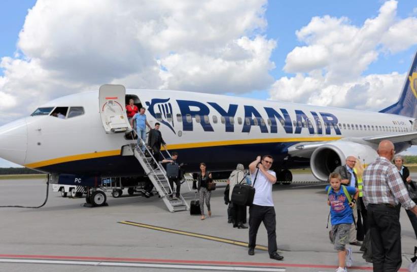 File photo of passangers leaving a Ryanair aircraft at Modlin airport near Warsaw, Poland June 26, 2014.  (photo credit: REUTERS)