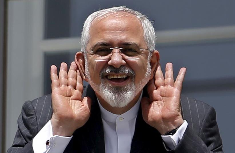 Iranian Foreign Minister Mohammad Javad Zarif gestures as he talks with journalist from a balcony of the Palais Coburg hotel where the Iran nuclear talks meetings are being held in Vienna, Austria (photo credit: REUTERS)