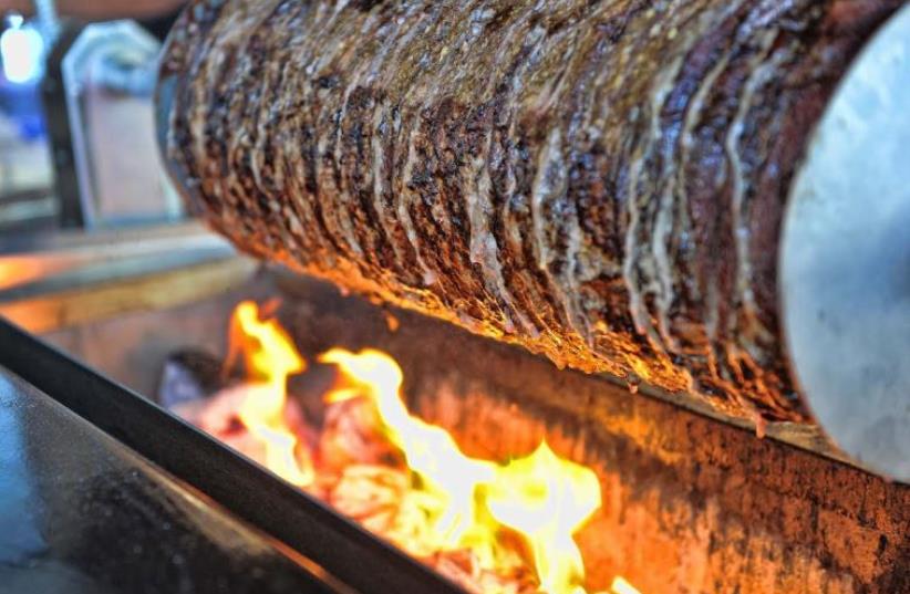 Shawarma roasting over coals at Bandura in Bnei Brak (photo credit: ELAD GUTMAN)