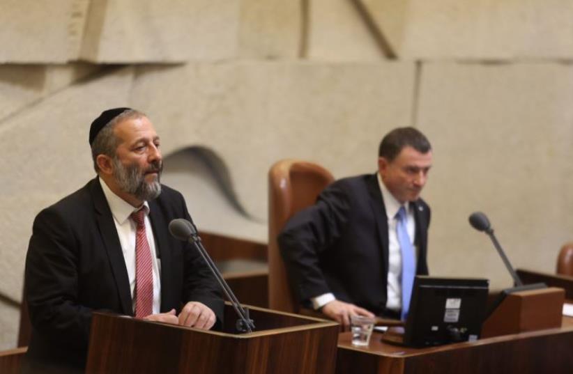 Economy Minister Aryeh Deri (L) speaks to the Knesset as speaker Yuli Edelstein looks on (photo credit: MARC ISRAEL SELLEM)