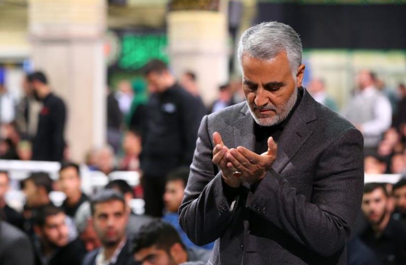 commander of the Iranian Revolutionary Guard's Quds Force, Gen. Qassem Suleimani, attending a religious ceremony in Tehran to commemorate the anniversary of the death of Fatima, the daughter of Prophet Mohammed. (photo credit: AFP PHOTO)