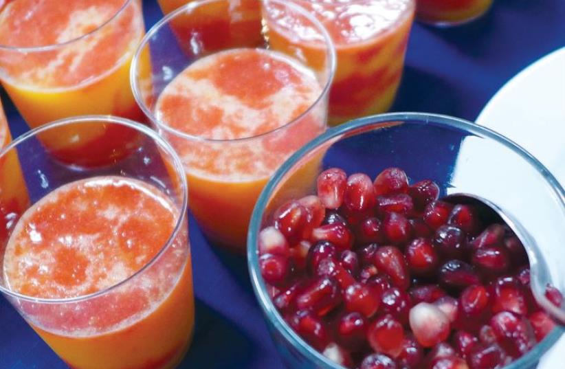 ‘Fruit cocktail’ with fresh pomegranate seeds, strawberries, orange juice and sugar. (photo credit: YAKIR LEVY)