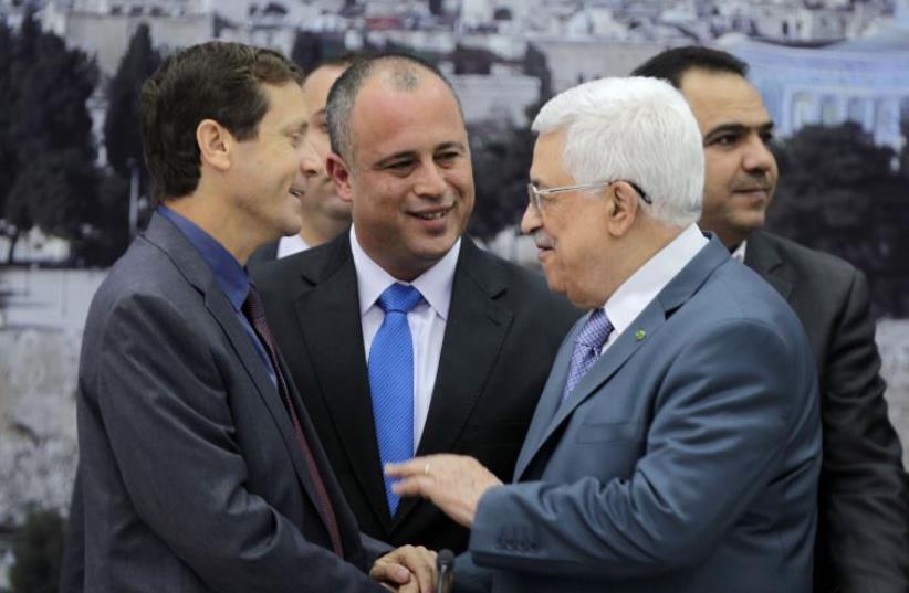 Zionist Union MKs Isaac Herzog (L) and Hilik Bar (C) shake hands with Palestinian President Mahmoud Abbas as they attend a meeting in Ramallah (photo credit: REUTERS)