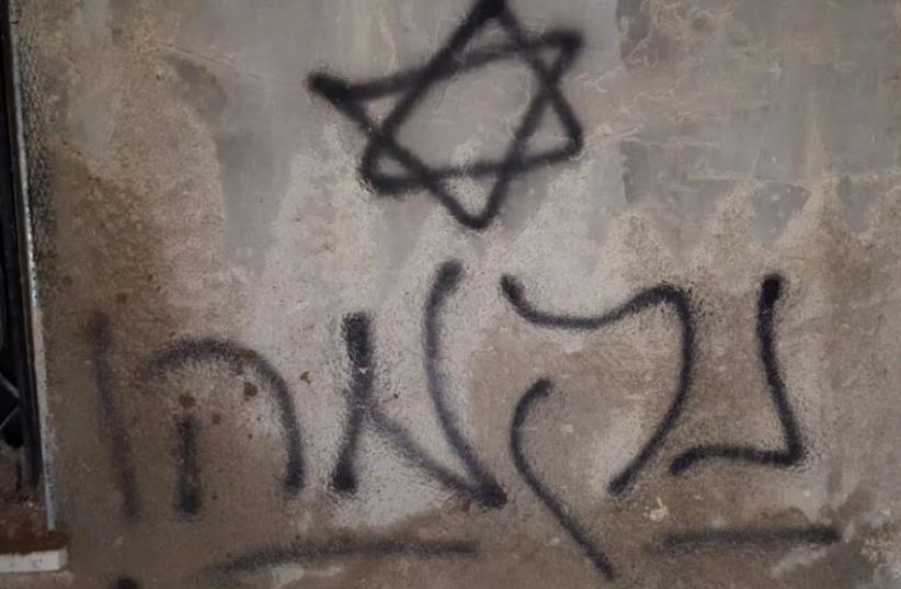 Hebrew grafitti at the Dawabsha family home in Duma where a fire engulfed the house after a molotov cocktail was thrown at it (photo credit: ZAKARIA, RABBIS FOR HUMAN RIGHTS)