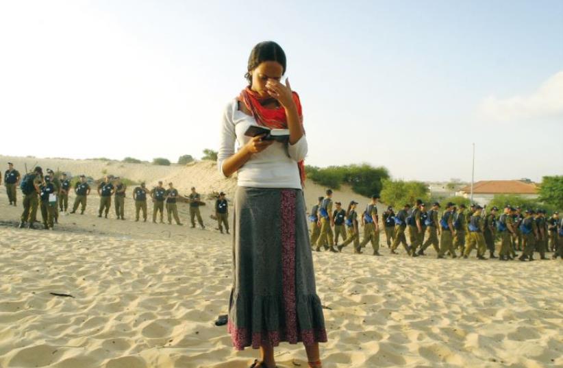 A woman prays during the evacuation of Gush Katif in 2005. (photo credit: ILLUSTRATIVE/RONEN ZVULUN/REUTERS)
