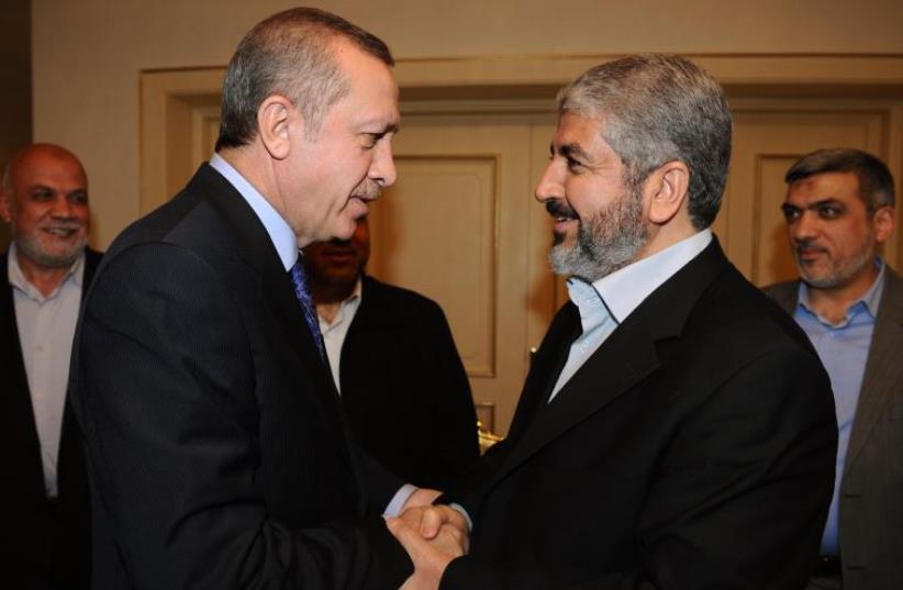 Turkey's Recep Tayyip Erdogan shakes hands with Hamas leader Khaled Mashaal [File] (photo credit: YASIN BULBUL / TURKISH PRIME MINISTER OFFICE / AFP)