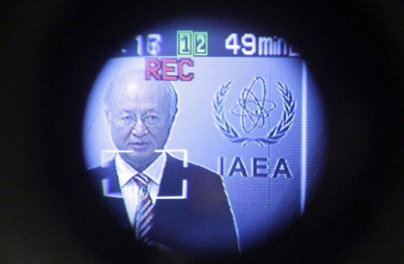 International Atomic Energy Agency (IAEA) Director-General Yukiya Amano is seen through a video camera viewfinder as he attends a news conference in Vienna (photo credit: REUTERS)