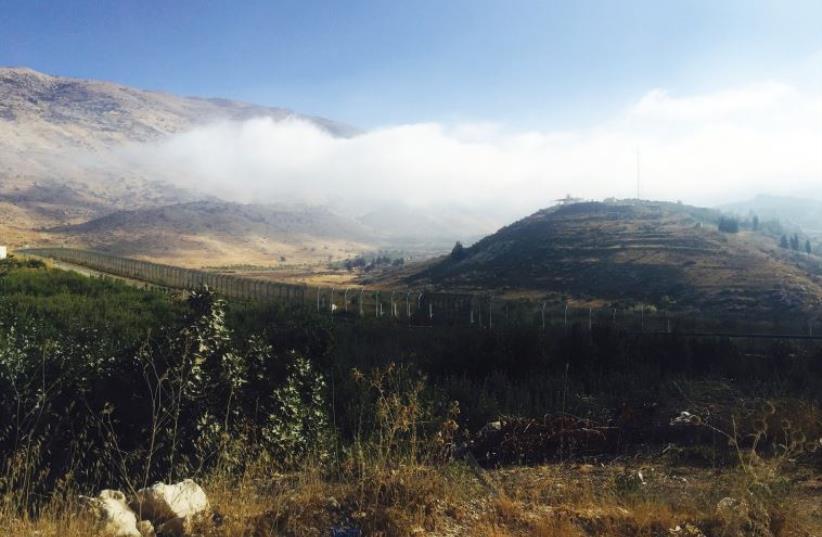 A VIEW ACROSS near Majdal Shams across the Golan border fence into Syria (photo credit: SETH J. FRANTZMAN)