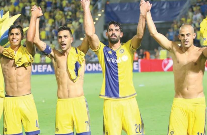 Maccabi Tel Aviv teammates celebrating their club’s progress to the Champions League group stage, August 25, 2015 (photo credit: ADI AVISHAI)