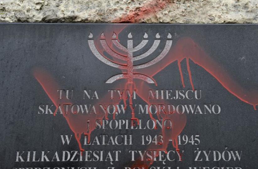 Anti-Semitic graffiti is seen on a monument dedicated to the victims of the Krakow ghetto located at the site of the former concentration camp in Plaszczow (photo credit: REUTERS)