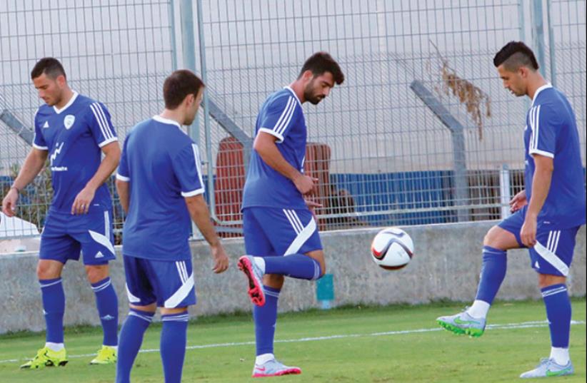 The Israel squad made its final preparations for tonight’s Euro 2016 qualifier against Andorra yesterday, with (from left) Tomer Hemed, Bibras Natcho, Omri Ben-Harush, and Beram Kayal all vying for a starting role at Sammy Ofer Stadium in Haifa. (photo credit: ADI AVISHAI)