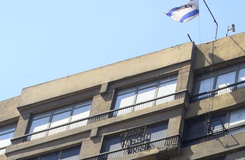 An Israeli flag flies at the top of the Israeli embassy in Cairo August 19, 2011 (photo credit: REUTERS)