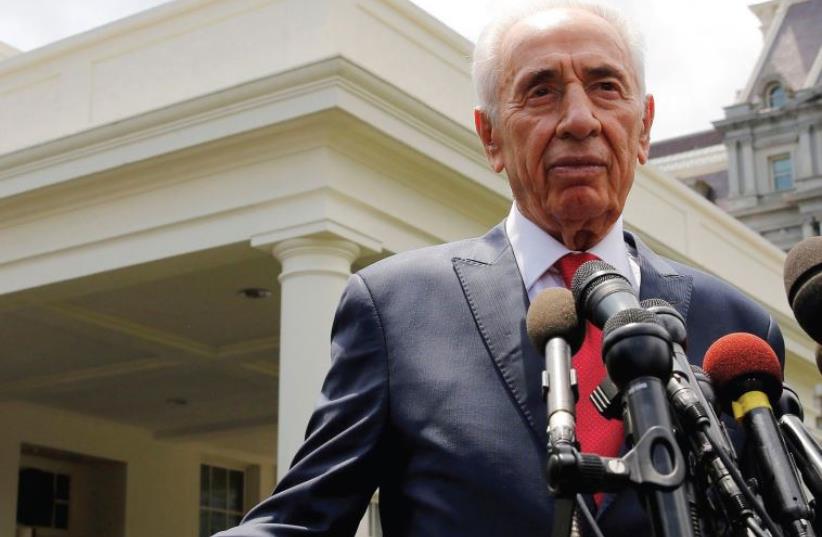Former President Shimon Peres talks to the press after meeting with US President Barack Obama in the Oval Office of the White House during his presidency last June (photo credit: REUTERS)
