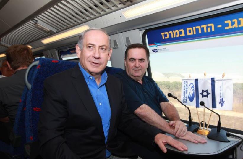 Prime Minister Benjamin Netanyahu and Transportation Minister Yisrael Katz ride an Israel Railways train (photo credit: ELIYAHU HERSHKOVITZ/POOL)