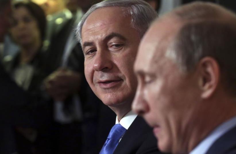 Russian President Vladimir Putin (R) and Prime Minister Benjamin Netanyahu attend a news conference in Sochi (photo credit: REUTERS)