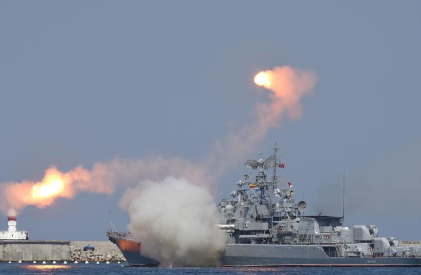 A Russian warship fires [File] (photo credit: REUTERS)