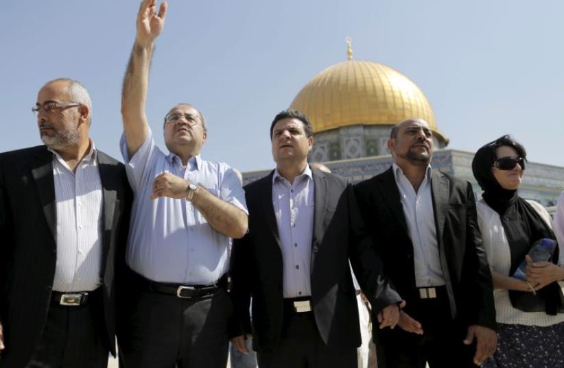Israeli Arab lawmakers from the Joint List (from L to R) Osama Saadi, Ahmed Tibi, Ayman Odeh, Masud Ganaim and Haneen Zoabi stand in front of the Dome of the Rock (photo credit: REUTERS)