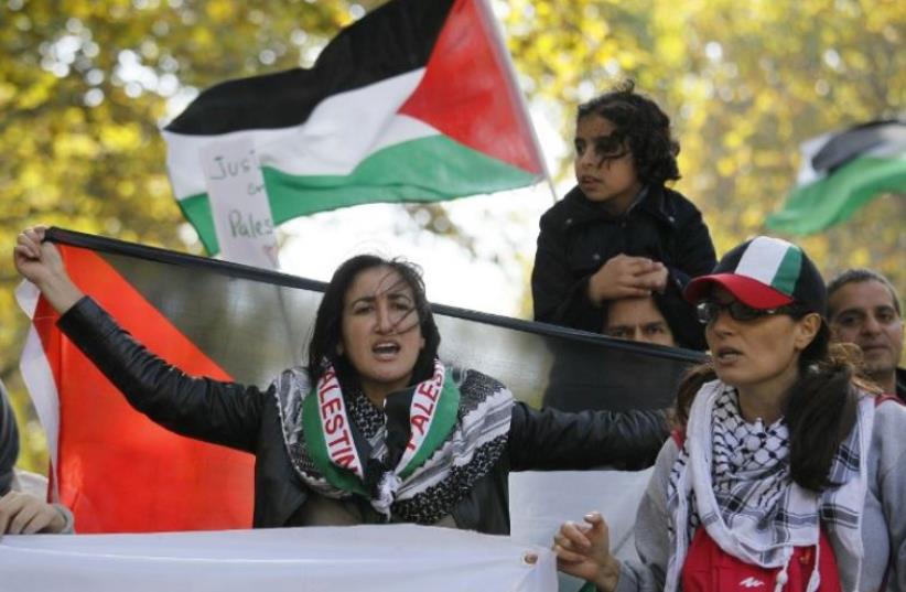 Pro-Palestine demonstrators calling for a boycott during a protest in Paris (photo credit: AFP PHOTO)