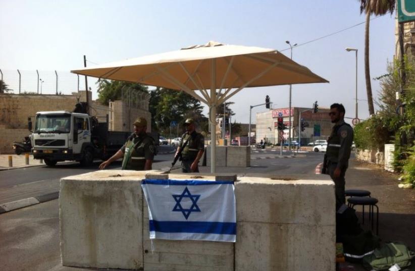 POLICE GUARD a checkpoint set up in Abu Tor on Monday (photo credit: JERUSALEM POLICE)