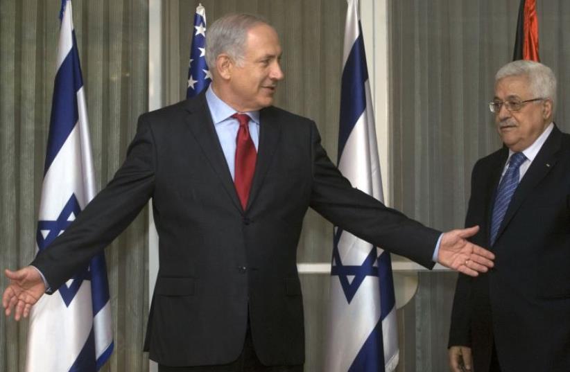 srael's Prime Minister Benjamin Netanyahu (L) gestures beside Palestinian President Mahmoud Abbas before their meeting in Jerusalem September 15, 2010 (photo credit: REUTERS)