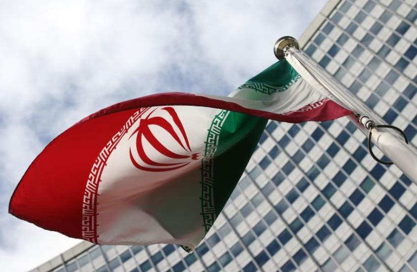 An Iranian flag flutters in front of the United Nations headquarters (photo credit: REUTERS)