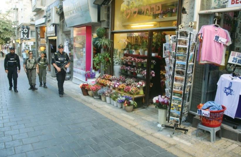 Walking down the normally bustling Ben-Yehuda Street, one finds the heart of Jerusalem uncannily empty (and security out in force) (photo credit: MARC ISRAEL SELLEM/THE JERUSALEM POST)