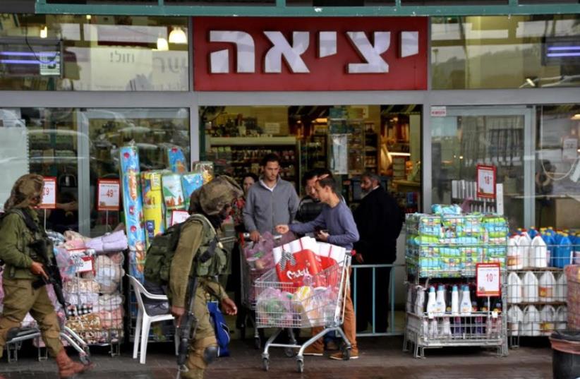 Soldiers patrolling the parking lot by the Rami Levi supermarket in the Gush Etzion commercial center (photo credit: TOVAH LAZAROFF)