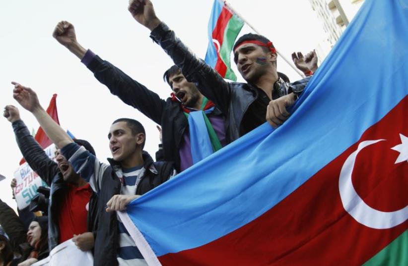 People attend an opposition rally in Baku (photo credit: REUTERS)